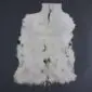 Natural white goatskin rug with long, textured fur and an irregular organic shape .