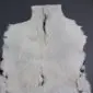 Natural white goatskin rug with a dark grey dorsal stripe and irregular edges.