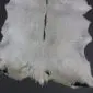Natural goatskin rug with light grey and white fur, featuring a dark grey stripe down the centre.