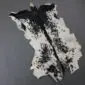 Natural goatskin rug with a white base and a prominent black dorsal stripe and speckled markings.