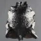 Natural goatskin rug with a dark brown and black centre fading into speckled white edges.