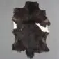 Goatskin Rug G1042 (2) Natural goatskin rug with dark brown and black fur featuring small white patches on the sides.