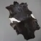 Goatskin Rug G1042 (4) Natural goatskin rug with dark brown and black fur featuring white patches on the sides.