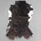 Natural goatskin rug with dark brown and black fur featuring white patches on the sides.