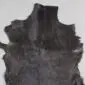 Goatskin Rug G1045 (3) Natural goatskin rug with dark brown and black textured fur in an irregular shape.