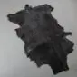Goatskin Rug G1045 (4) Natural black goatskin rug with an irregular shape and short hair texture.