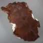 Goatskin Rug G1058 (4) Natural goatskin rug with dark brown fur and white patches along the edges.