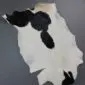 Goatskin Rug G1065 (4) Natural goatskin rug featuring a white base with large black patches and tan highlights.