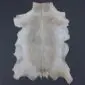 Natural white goatskin rug with light brown markings and an irregular shape.