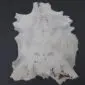 Natural goatskin rug with light grey and white fur featuring subtle dark grey and brown markings.