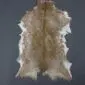 Goatskin Rug G1075 (2) Natural goatskin rug with tan and white mottled fur and an irregular organic shape.