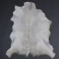 Natural goatskin rug with cream and light grey fur in an irregular hide shape.