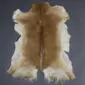 Natural goatskin rug with tan and cream fur, featuring a dark brown stripe down the centre.