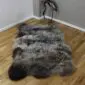 Triple rare breed sheepskin rug with long, thick wool in mottled shades of grey, cream and dark brown.