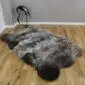 Triple rare breed sheepskin rug with long, textured wool in mottled grey, brown and cream tones.