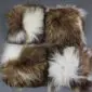 Four square Icelandic sheepskin cushions with long, shaggy wool in spotted rusty brown and white patterns.