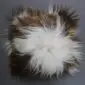 Square Icelandic sheepskin cushion with long, shaggy wool in a spotted white and rusty brown pattern.