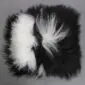 Square Icelandic sheepskin cushion with long, shaggy black and white spotted wool.