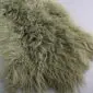 Khaki Mongolian lambskin rug with long, curly wool texture. detail view