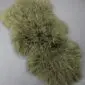 Khaki Mongolian lambskin rug with long, curly wool fibres and a natural organic shape.