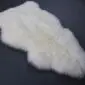 IMG_3427 Two ivory white sheepskin rugs with long wool pile and natural organic shapes.