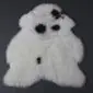 Icelandic Sheepskin Rug IMX134 (2) Shorn Icelandic sheepskin rug in white with natural black spots and an irregular organic shape.
