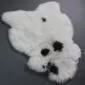 Icelandic Sheepskin Rug IMX134 (4) Natural white shorn Icelandic sheepskin rug with irregular black spots and a thick, woolly texture.