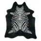 Natural shaped cowhide rug featuring a black and white zebra print pattern.