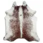 Natural cowhide rug with white edges and a brown speckled centre.