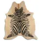 Natural shaped cowhide rug with a cream base and black zebra print pattern.