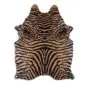 Natural shaped cowhide rug with a brown and beige zebra print pattern.