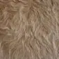Cowhide Rug C01077 (1) Close-up of a beige cowhide rug with long, textured natural hair.