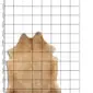 Cowhide Rug C01077 a (1) Natural shaped cowhide rug in beige and light brown tones with speckled patterns, displayed .