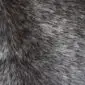 Close-up of a speckled cowhide rug with grey, black, and white natural hair textures.