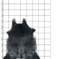 Natural cowhide rug with black and white speckled patterns and an irregular shape on a grid background.