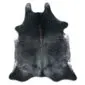 Natural cowhide rug with a dark grey and black speckled pattern and an irregular organic shape.