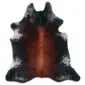 Natural cowhide rug with a dark brown and black centre, featuring white speckled edges and a unique organic shape.