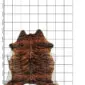 Cowhide Rug C01090 a (1) Natural cowhide rug with dark brown and black brindle stripes on a white background, displayed on a grid.