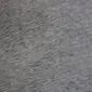 Close-up of a grey cowhide rug showing the natural hair texture and mottled grey tones.