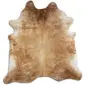 Natural cowhide rug with an irregular shape featuring speckled beige, tan, and cream fur tones.