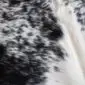 Close-up of a speckled cowhide rug featuring a natural black and white salt and pepper pattern.