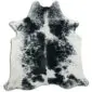 Natural shaped cowhide rug with a white base and black speckled salt and pepper pattern.
