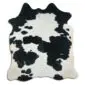 Cowhide Rug C01116 a (2) Natural cowhide rug with an irregular shape featuring a black and white spotted pattern.