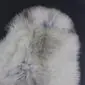Rare Breed Sheepskin Rug RBS149 (4) Close-up of a thick, cream sheepskin rug with natural grey and brown mottled markings.