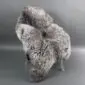 Large rare breed sheepskin rug with thick, textured wool in mottled shades of grey, cream, and brown.