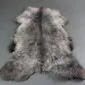 Extra large rare breed sheepskin rug with long, textured wool in mottled grey, cream and charcoal tones.