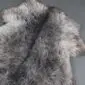 Extra large rare breed sheepskin rug with long, textured wool in mottled grey, cream and charcoal tones. detail view