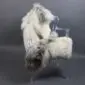 Large multi-layered sheepskin rug in cream and grey laid flat.