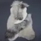 Large multi-layered sheepskin rug with long grey and white wool in an irregular natural shape.