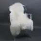 Large multi layer white sheepskin rug with long thick wool laid flat.